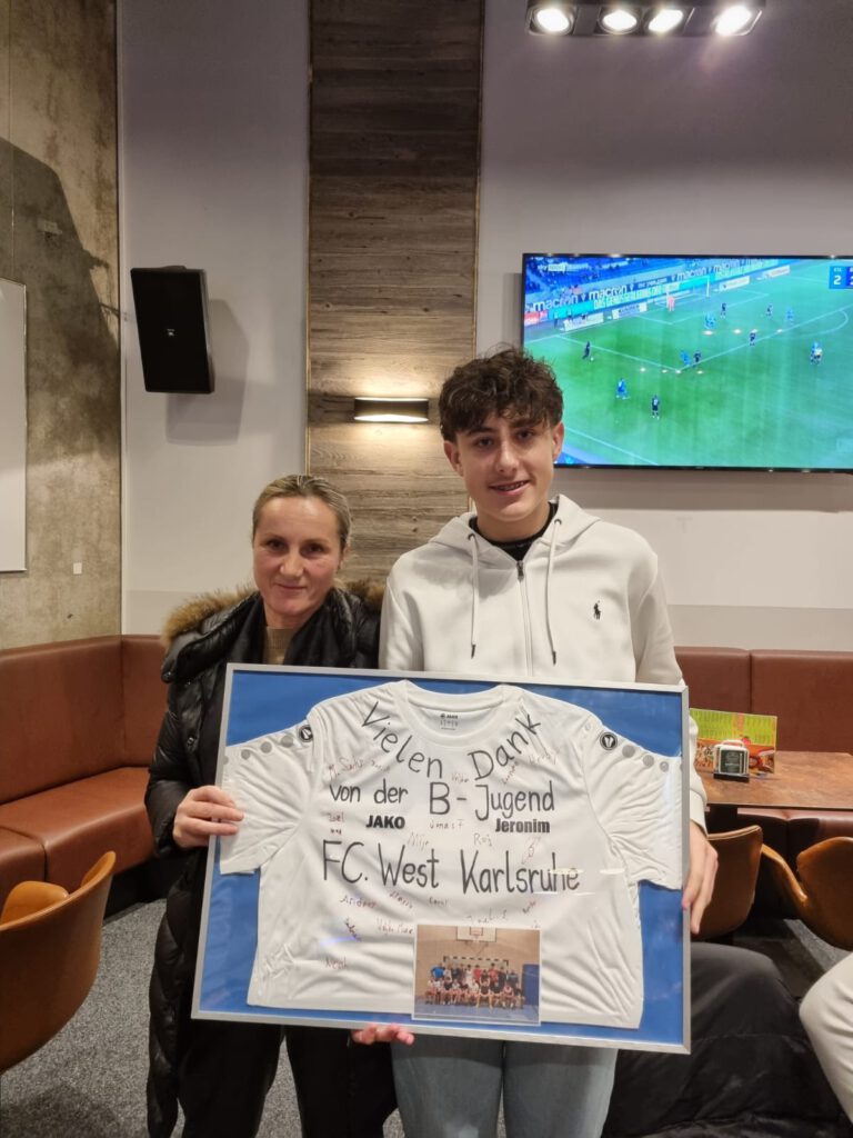 Sponsorin Frau Tomic mit dem von den Jungs unterschriebenen Trikot